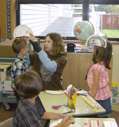 Stidgrant helps put the masks on the kids' heads