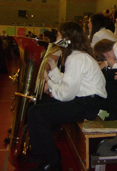 tuba holds music while the stidkid waits to play