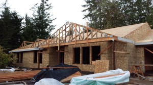 Dormers ready.  You can see how nice the front porch will be, providing a bit of a dry(er) landing space for people coming in.  Secondary dormers over the front bedroom windows (one is Tom's office, of course).