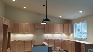 The kitchen, showing the empty space for the refrigerator and a cabinet next to it for the wall oven, range on the far wall...  and on the right the space for the dishwasher.