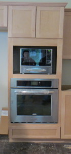 The ghostly images are me and Tom -- I am on the left.  My shoes are reflected in the oven, my face in the microwave.  Did not notice them when I snapped this pic!  The cabinetry looks all askew, but it is a function of the angle of the shot and my inability to line things up properly today.